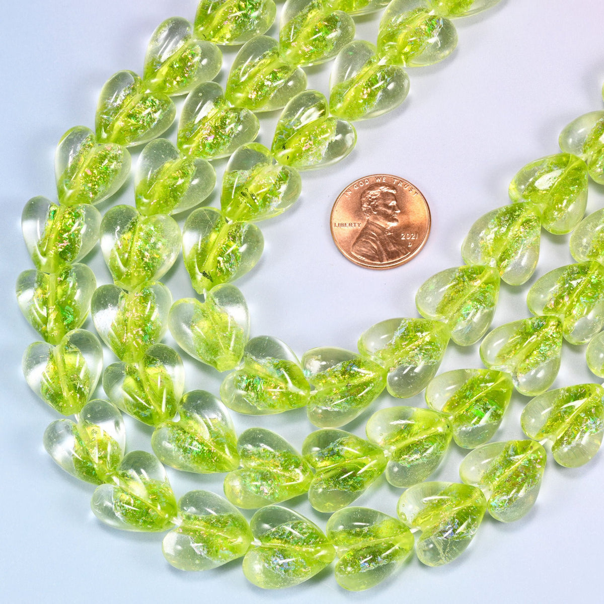 Clear glass heart beads flooded with bright lime and iridescent glitter