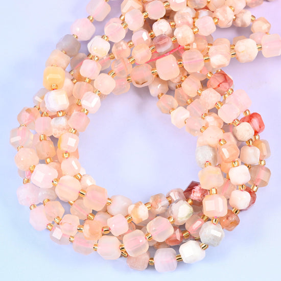 A cherry-blossom palette of blush pink, cream, chalk white and pale apricot, some cubes clouded and others clear enough to glow, with the odd coral fleck breaking through.