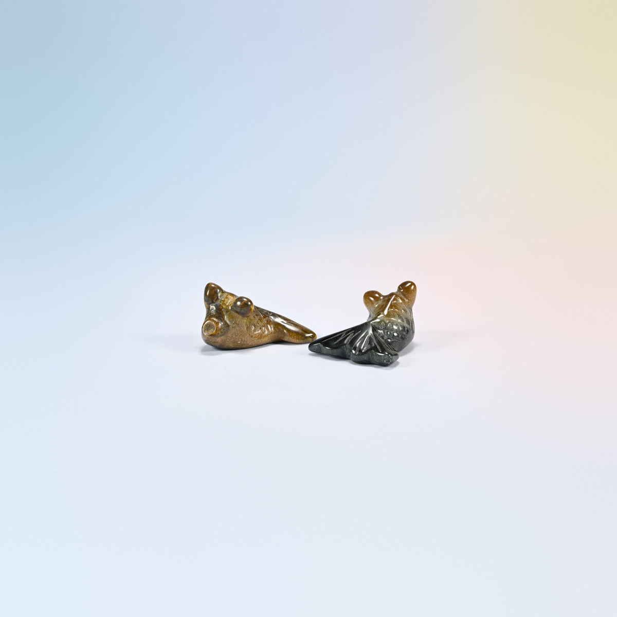 Two 1.5 inch natural tiger eye goldfish carvings, golden brown and dark chatoyant bands