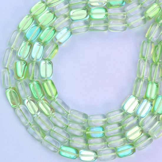 Green Mystic Aura glass beads, approximately 34 beads per strand