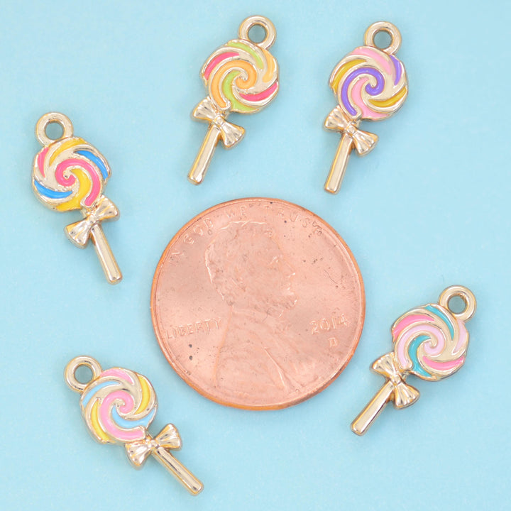Enamel lollipop charms arranged around a US penny, each charm smaller than the coin.