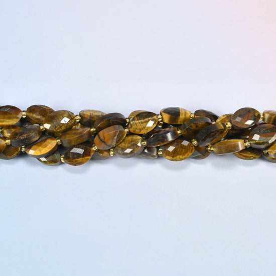 Strands of tiger eye faceted flat oval beads twisted together in a horizontal row