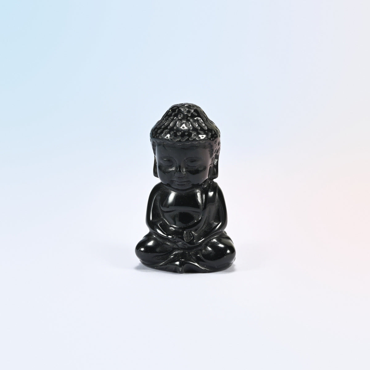 Natural black obsidian sitting Buddha carving with a glossy black polish, 2 inch