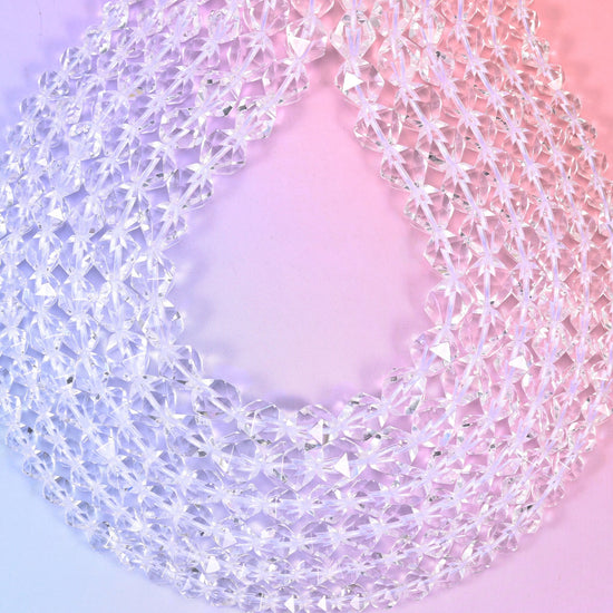 Clear Quartz diamond star cut beads close up, transparent rounds with sharp star facets