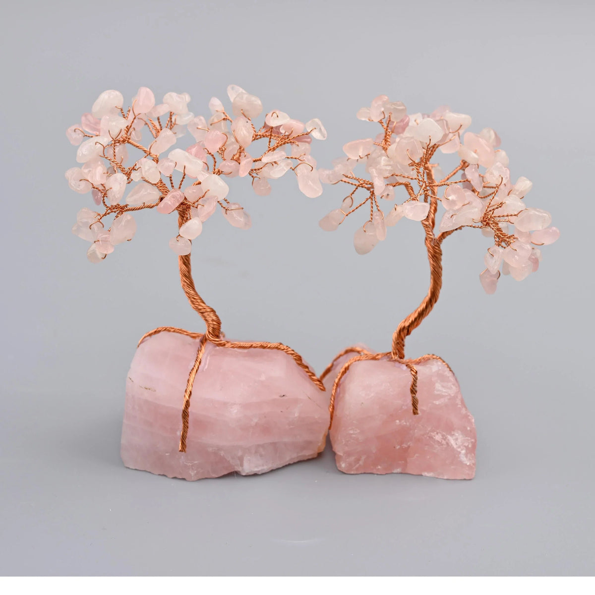 Rose quartz tree of life sculpture in pink stone with copper wire branches