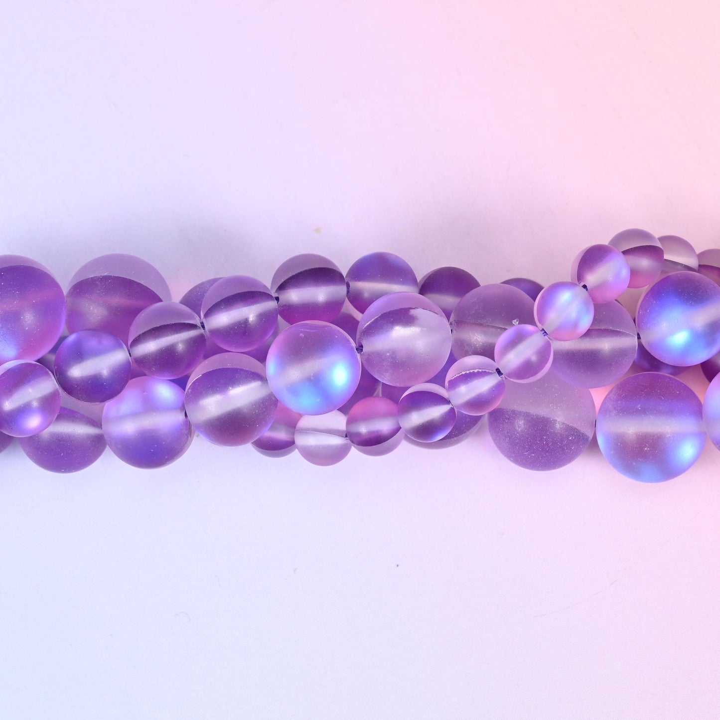 Soft violet and lilac glass beads with a frosted sea-glass surface