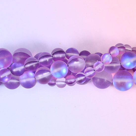 Soft violet and lilac glass beads with a frosted sea-glass surface