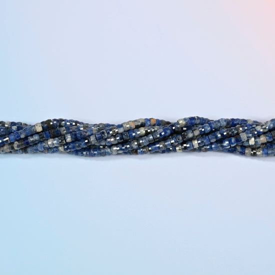 Strands of sodalite faceted heishi disc beads twisted together in a horizontal row