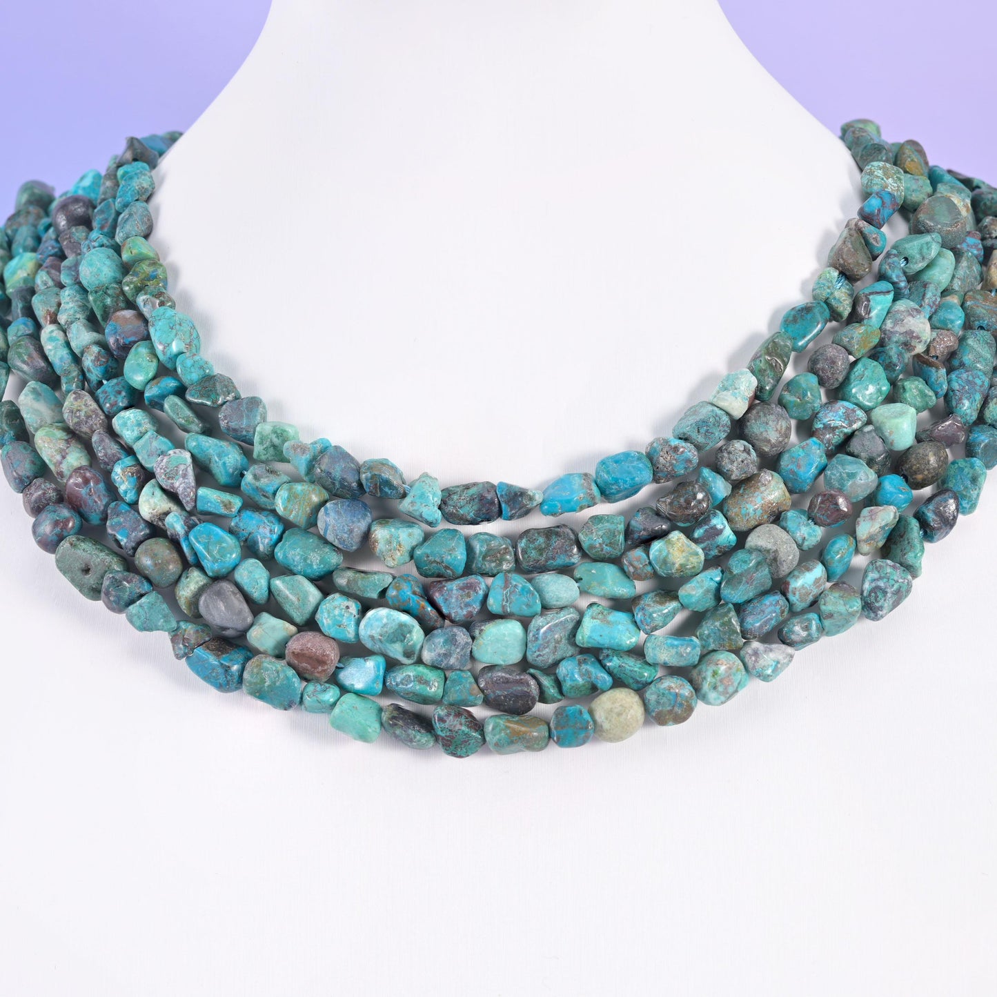 Blue turquoise nuggets layered on a display bust, five rows forming a banded collar