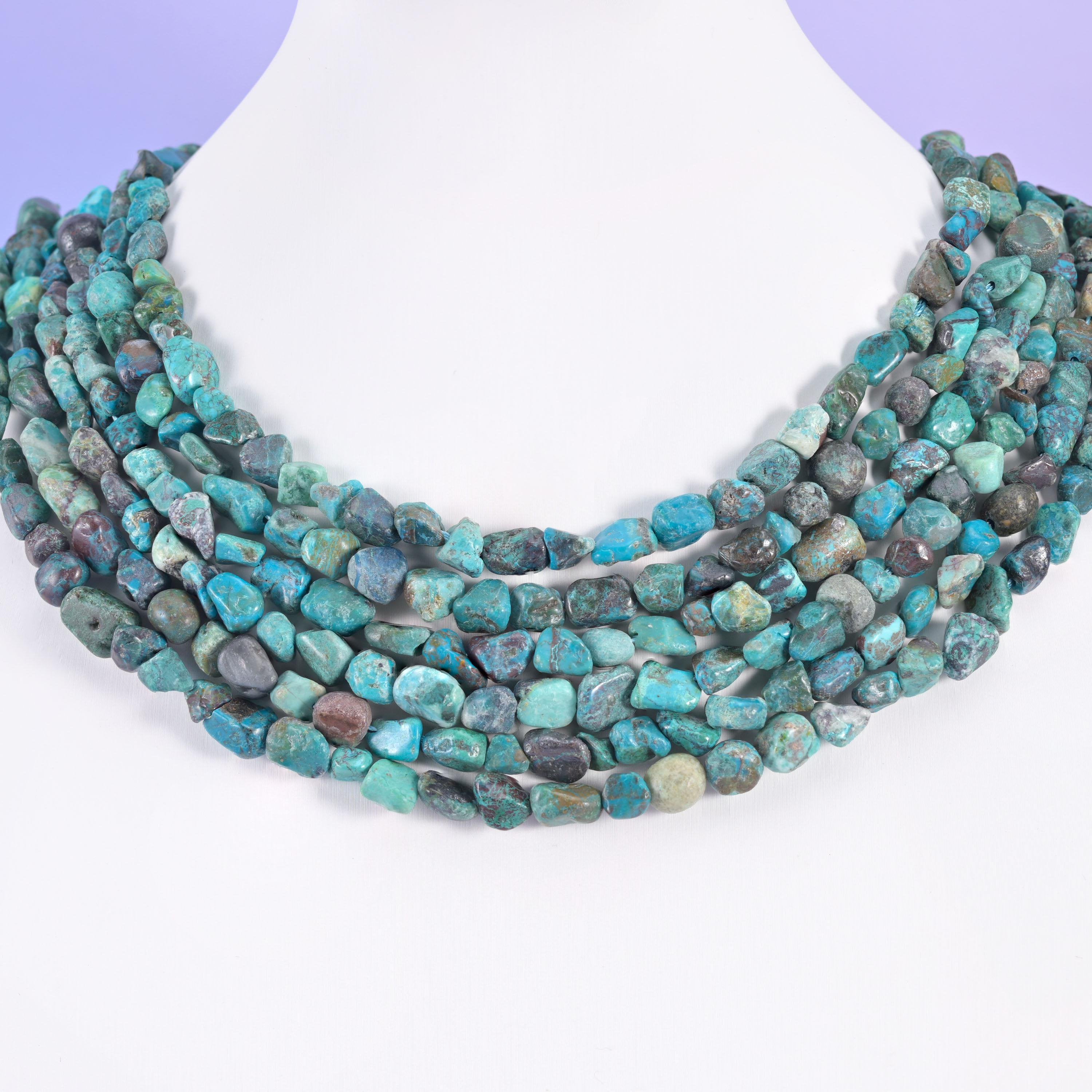 Blue turquoise nuggets layered on a display bust, five rows forming a banded collar