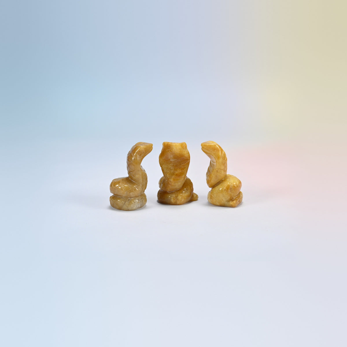 Cobra snake crystal carving in yellow jade, soft yellow natural stone