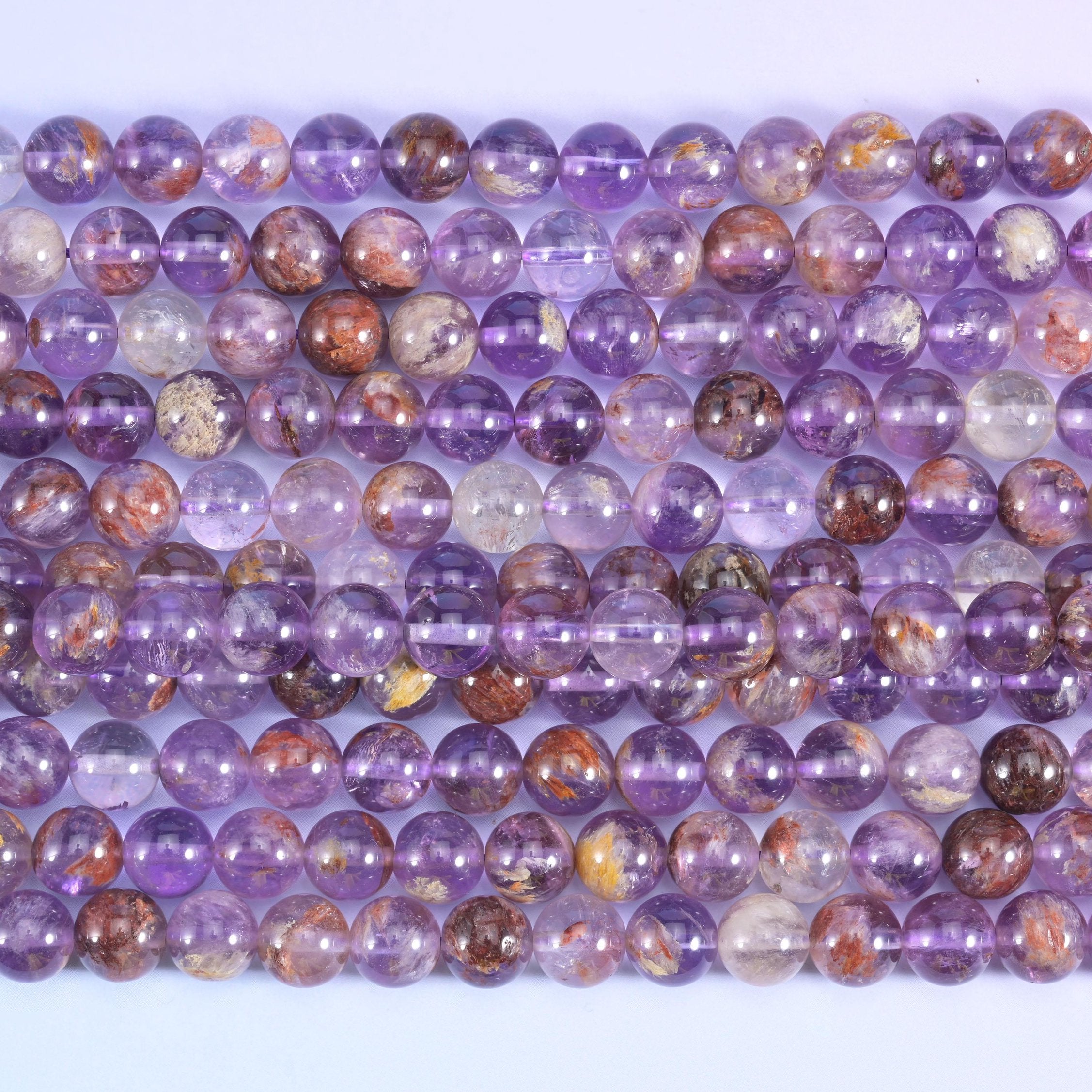 Smooth round cut Super 7 purple phantom quartz beads