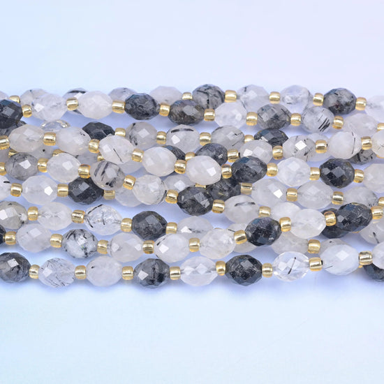Faceted rice barrel cut black rutilated quartz beads