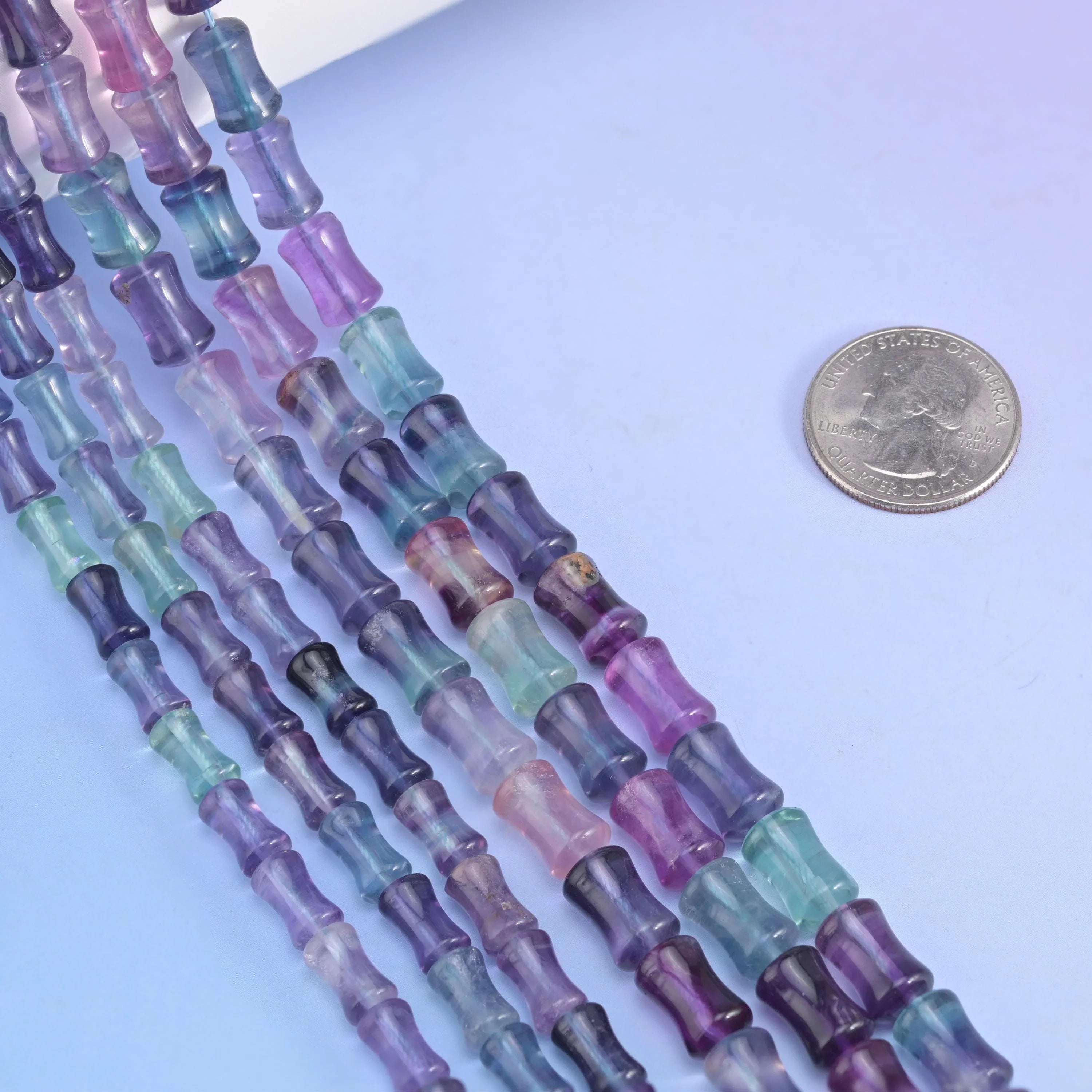 Bamboo stem cut Rainbow Fluorite beads, pinched waist shape.