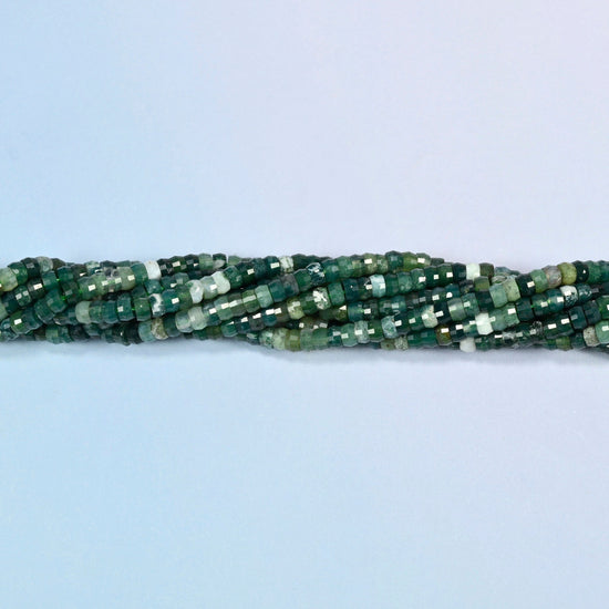 Strands of moss agate faceted heishi disc beads twisted together in a horizontal row