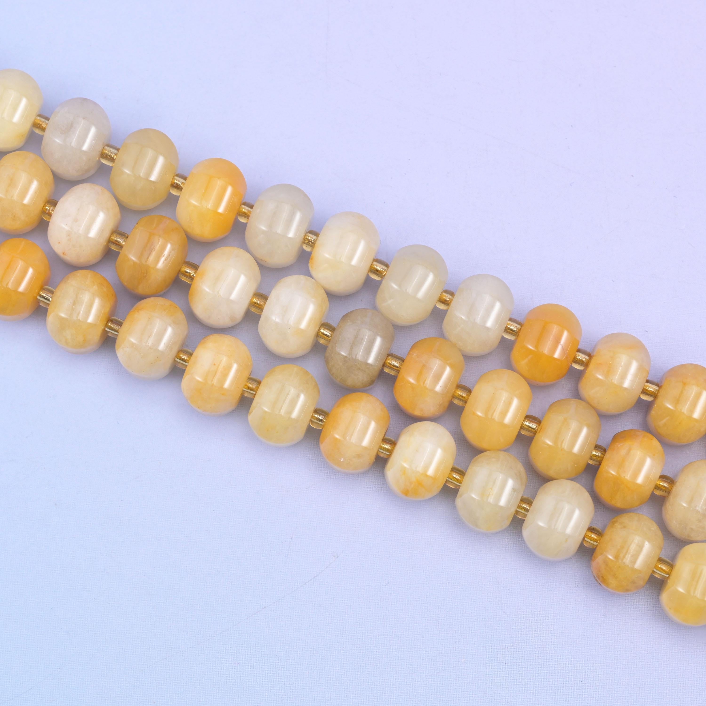 Yellow jade beads in warm honey-yellow with soft golden striations