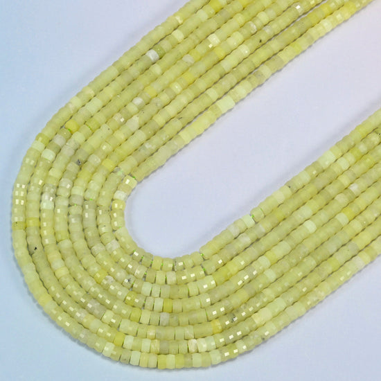 Lemon Jade faceted heishi disc beads in several strands curved into a wide U, light lemon yellow-green stone