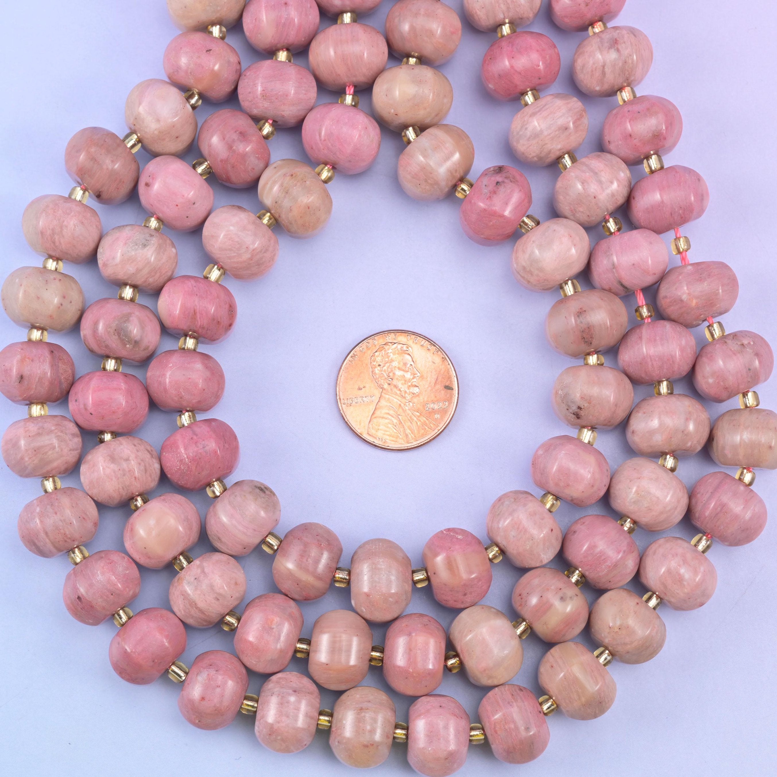 Pink rhodonite smooth pumpkin beads in warm mauve-pink with soft natural tonal shading
