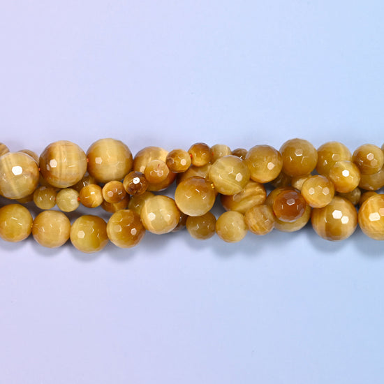 End detail of a golden brown gold tiger eye beaded strand (15-inch strand), showing bead spacing.