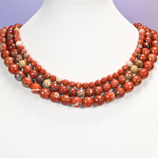 Close-up of flower red jasper round beads, showing the faceted finish and natural red tone.