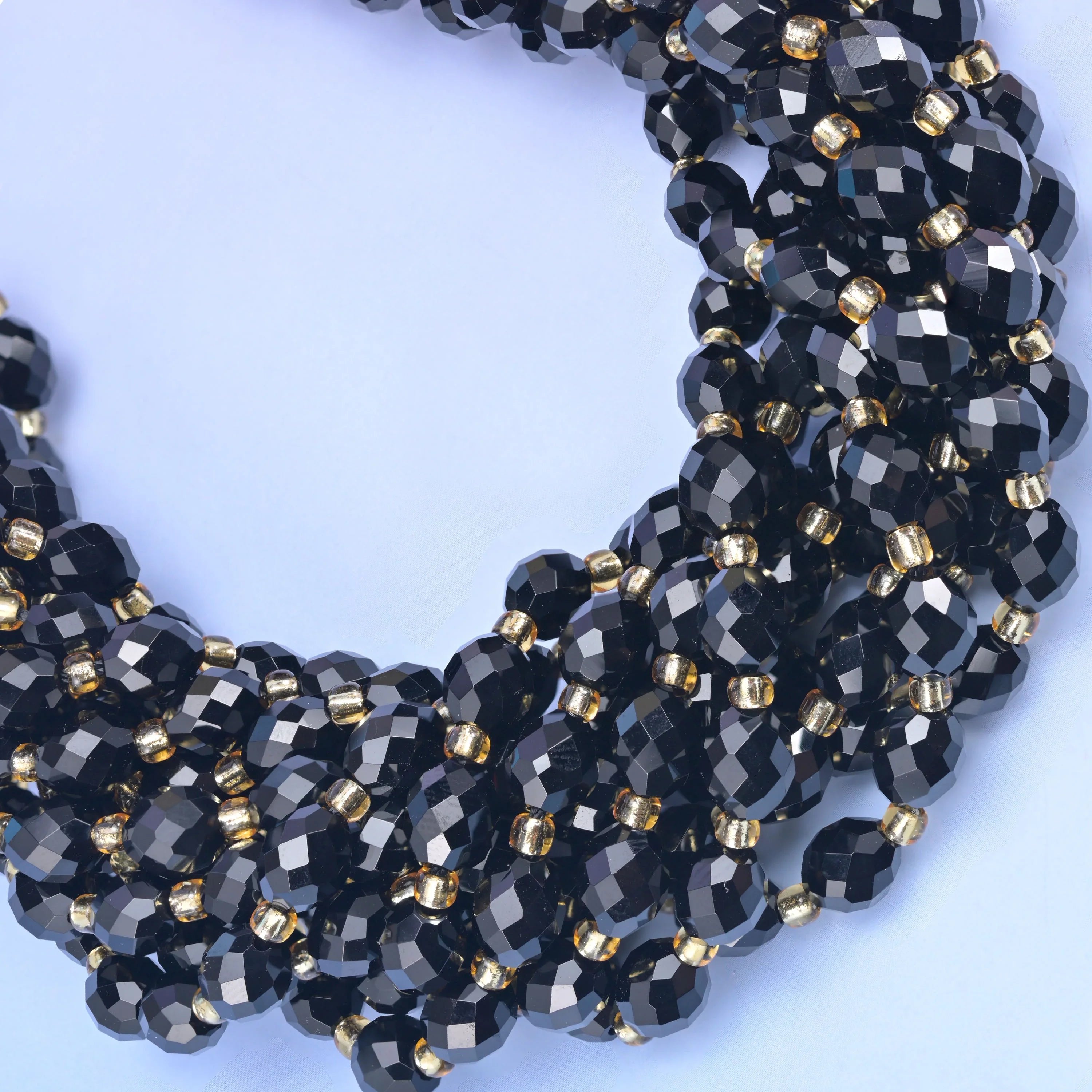 Faceted rice barrel cut black onyx beads for jewelry making.