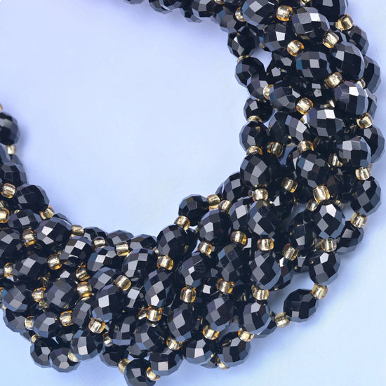 Faceted rice barrel cut black onyx beads for jewelry making.
