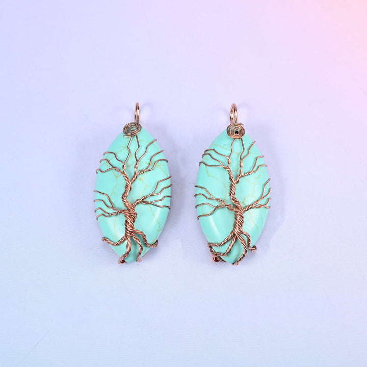 Oval Crystal Pendant with Copper Wired Tree in mint green stone, a matched pair with the copper trunk rising into a wrapped loop at the top.