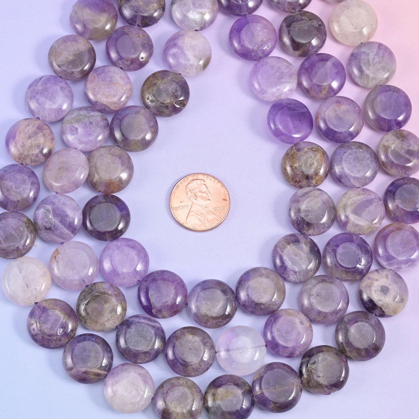 Amethyst coin loop framing a penny to show the 15mm bead scale