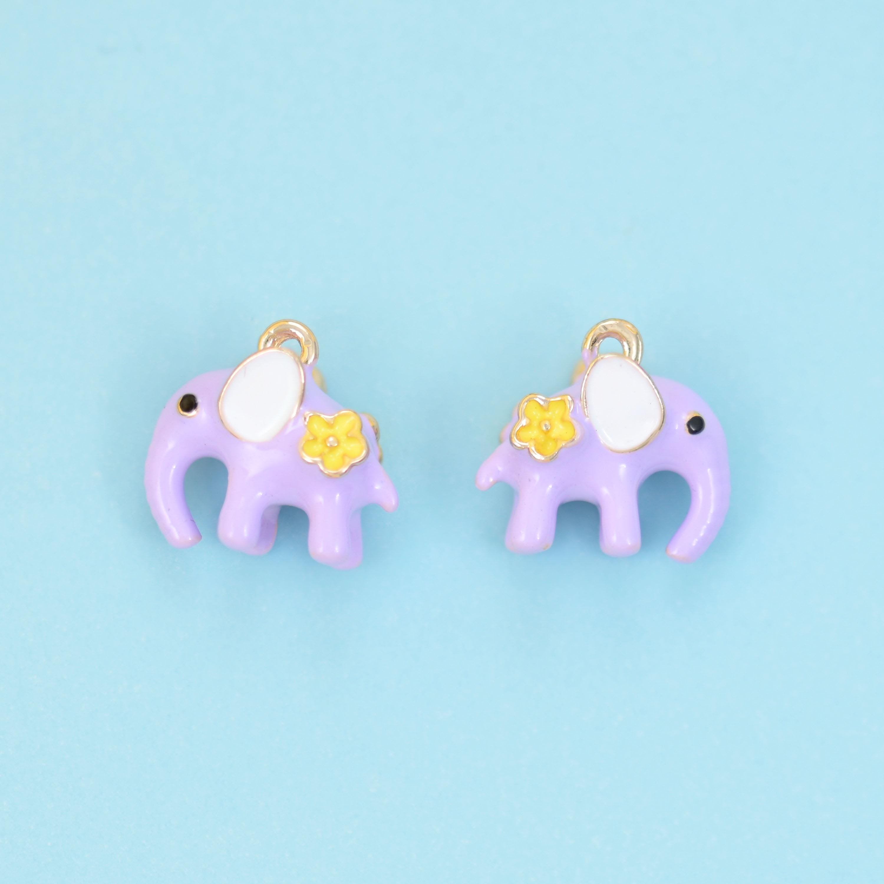 A little elephant in soft pastel enamel — dusty pink or lilac purple — with a cream-white ear, a dot of a dark eye and a…