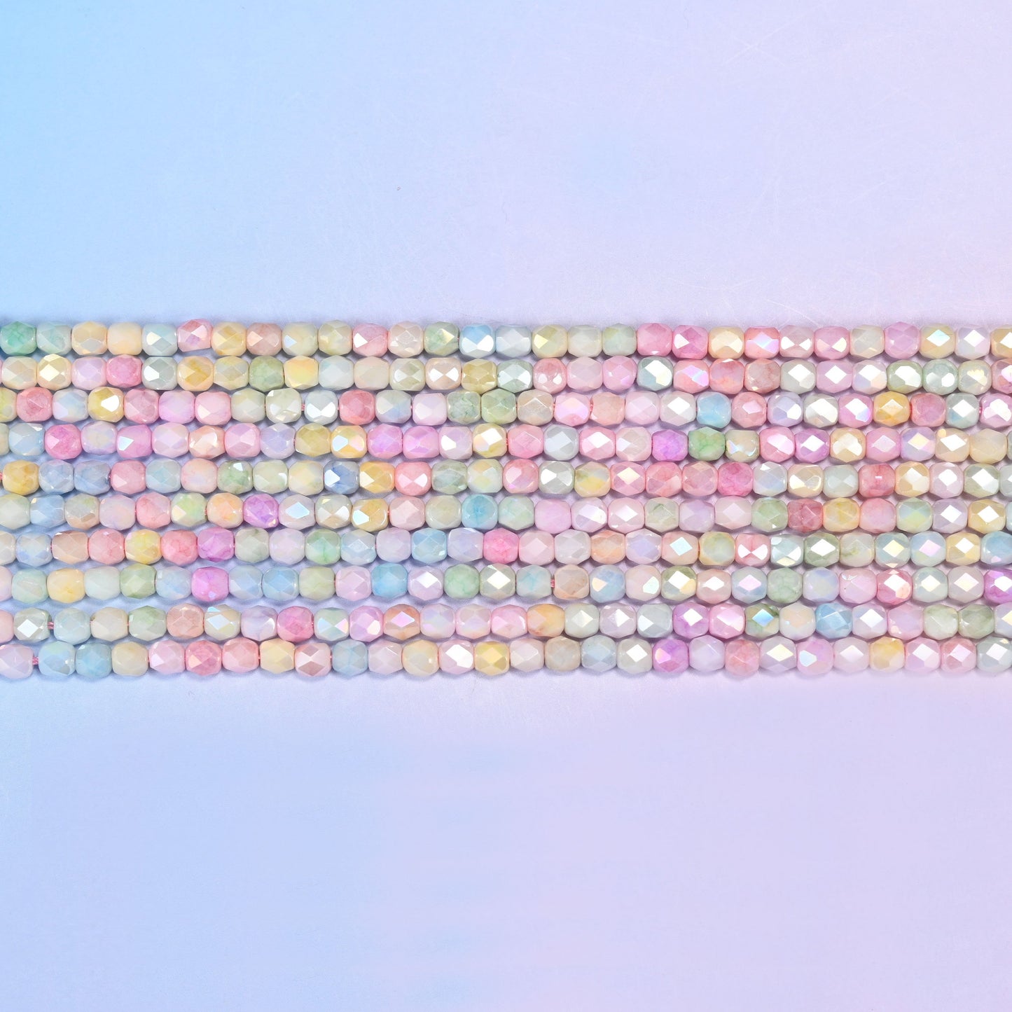 Tiny faceted barrels finished with a soft pearly sheen.
