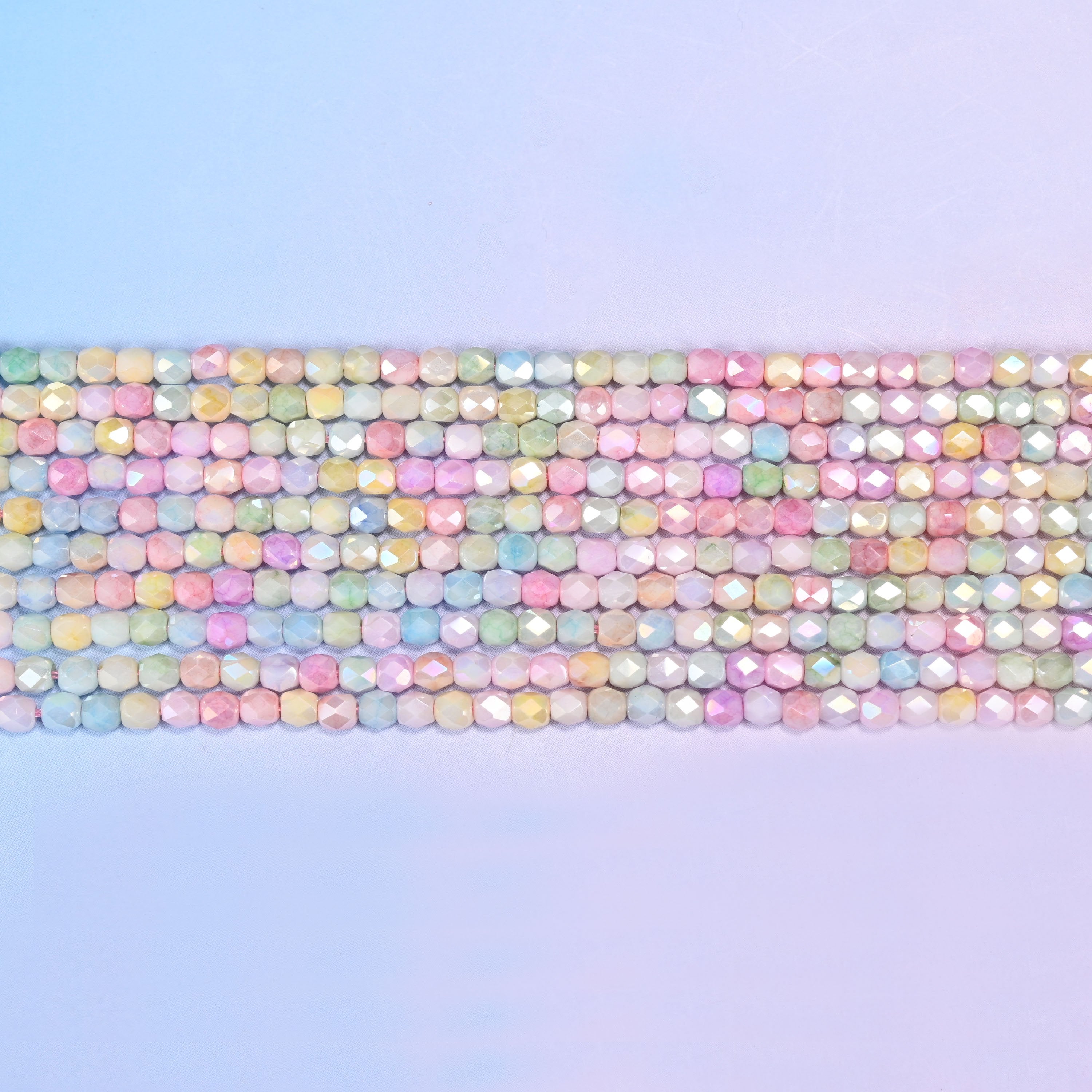 Tiny faceted barrels finished with a soft pearly sheen.
