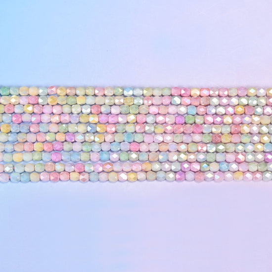 Tiny faceted barrels finished with a soft pearly sheen.