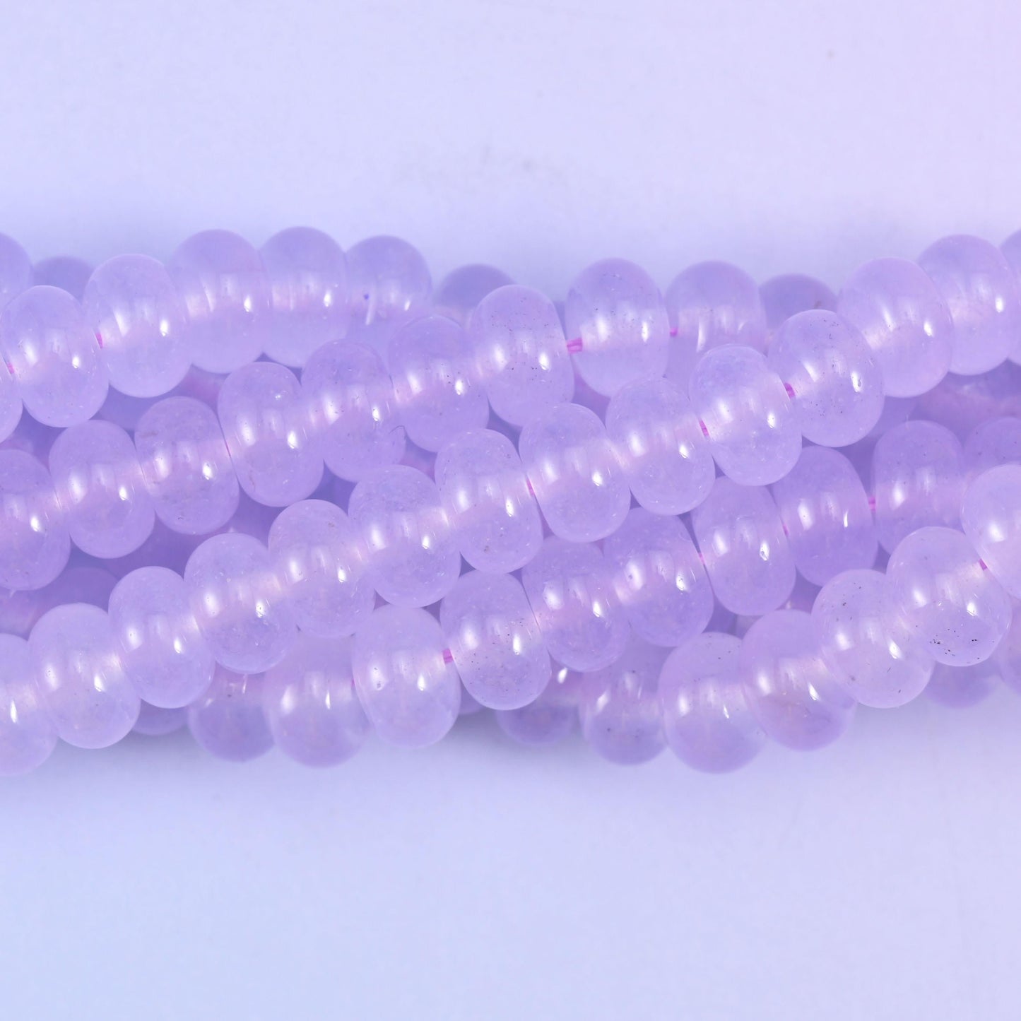 Smooth rondelle cut dyed jade beads with a polished surface