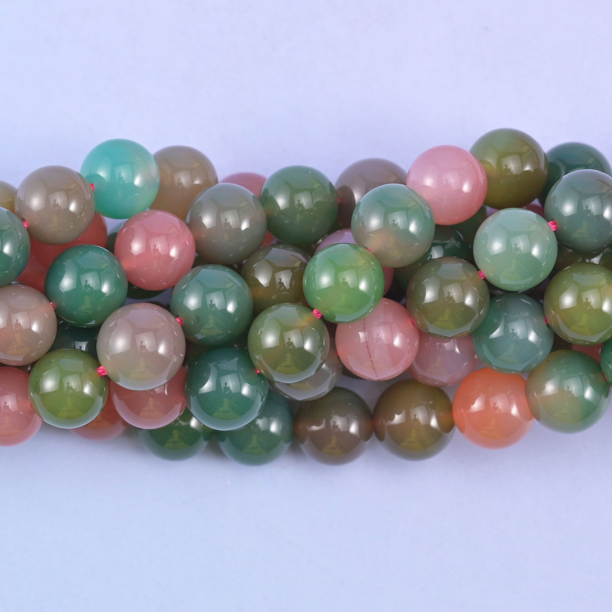 Green Yanyuan Agate round beads close up, centre drilled with a hole of approximately 1.0mm and a smooth polished finish