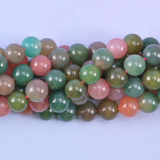 Green Yanyuan Agate round beads close up, centre drilled with a hole of approximately 1.0mm and a smooth polished finish