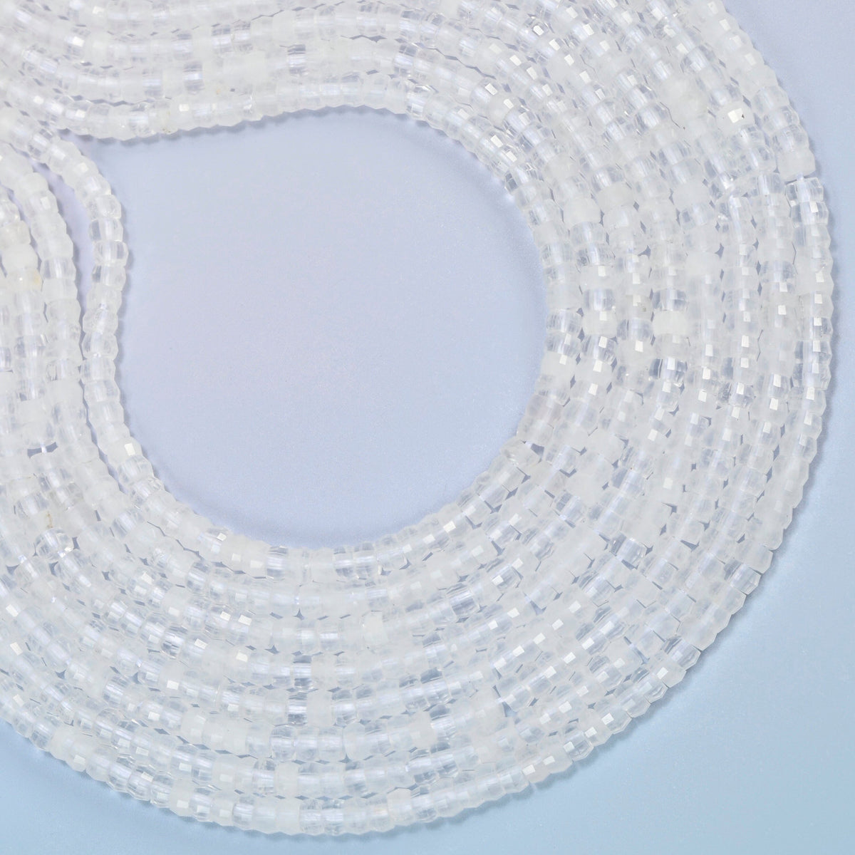 Clear quartz faceted heishi disc beads curved into an open loop, clear and milky white beads