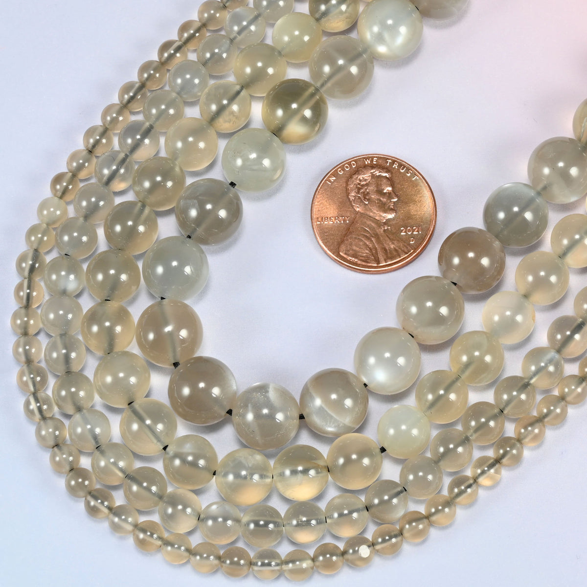 AAA Gray Labradorite smooth round beads in a deep loop, shown at their true size of 4mm to 10mm