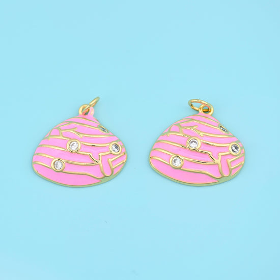 A scalloped clam shell in smooth enamel, its ridges drawn in fine raised gold and set with three tiny clear zircon stones…