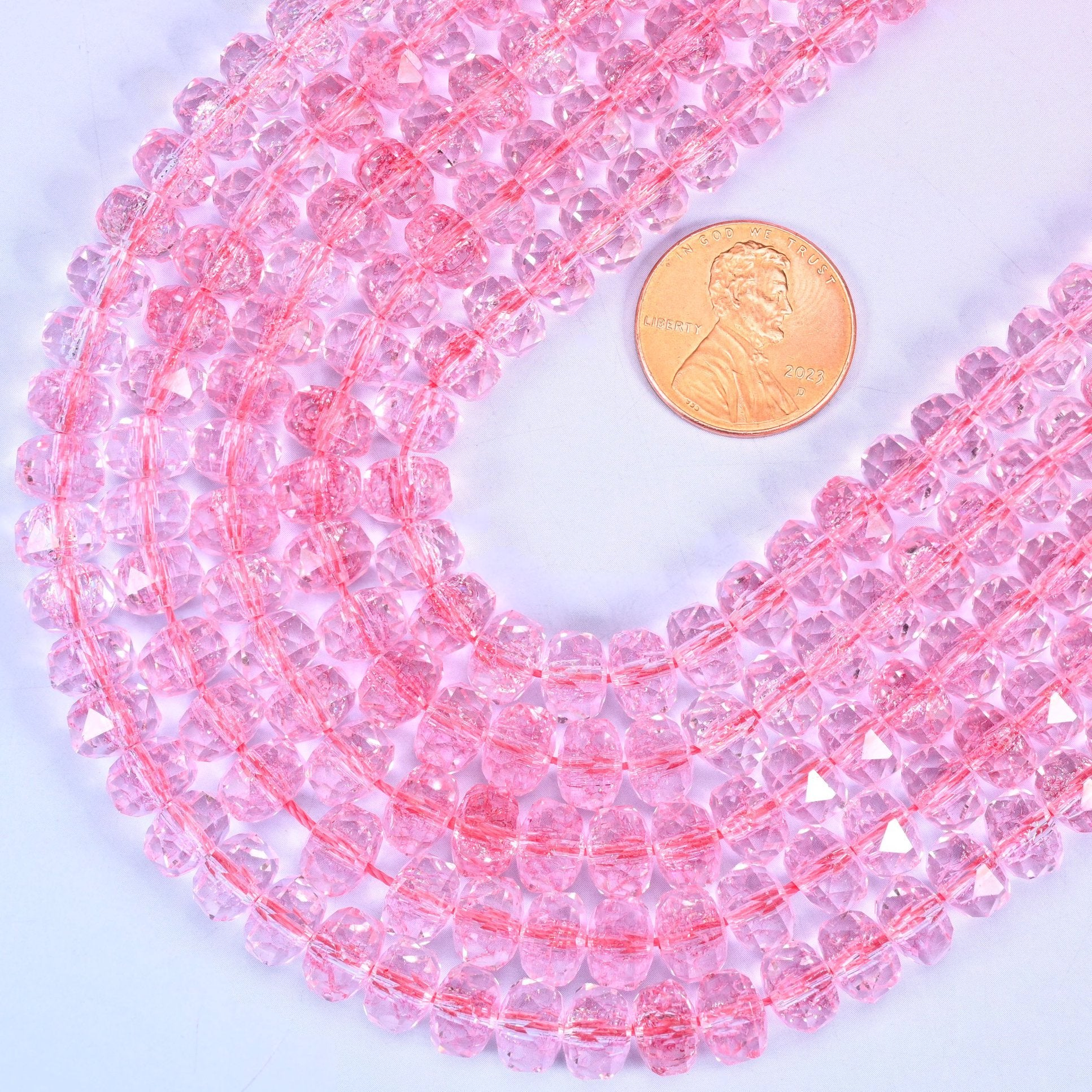 Faceted rondelle cut transparent pink glass beads