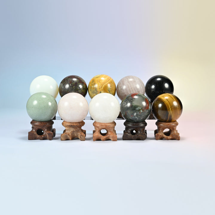 Ten gemstone sphere crystal balls on wooden display stands in natural stones and opalite, stands not included