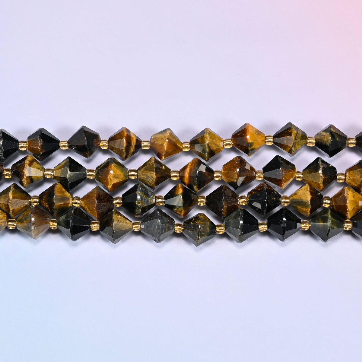 A single straight strand of 10mm Iron Tiger Eye faceted bicone beads laid flat, showing the full 15 inch length.
