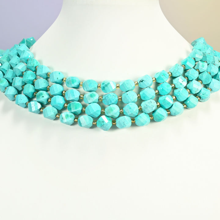Dyed blue green howlite faceted spiral twist strands arranged as a layered collar on a white display bust, mint turquoise beads across the neck