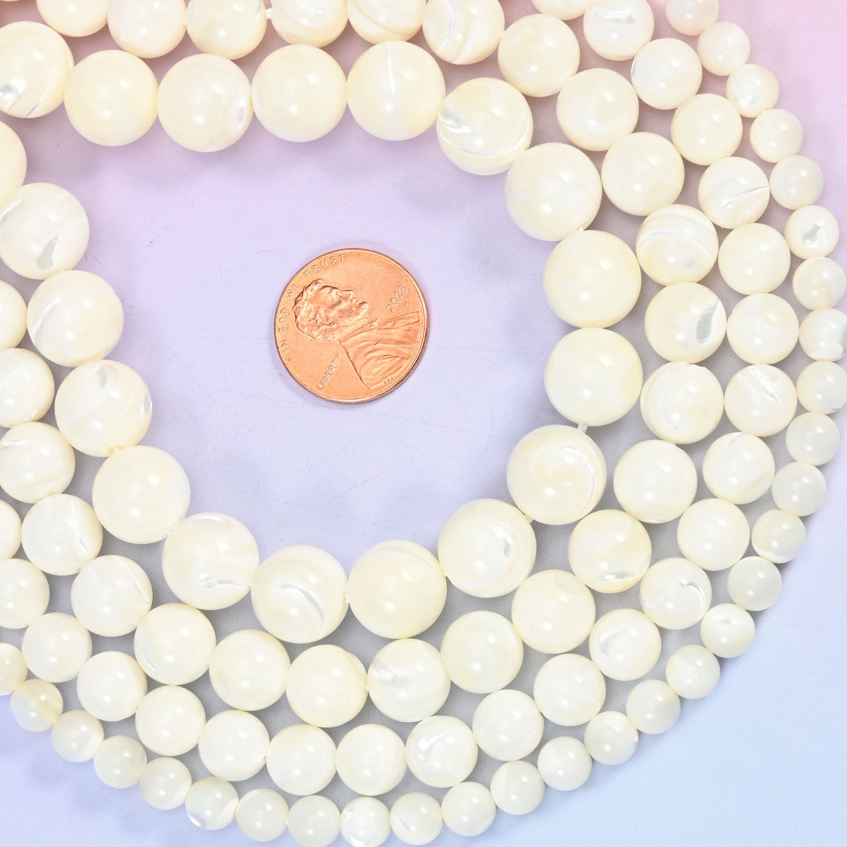 White trochus shell round beads, approximately 33 to 65 beads per strand depending on size