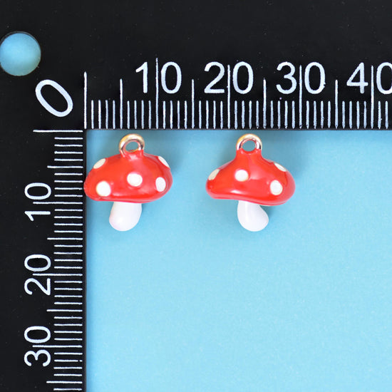 A chunky three-dimensional toadstool with a domed scarlet cap spotted in white and a short glossy white stem