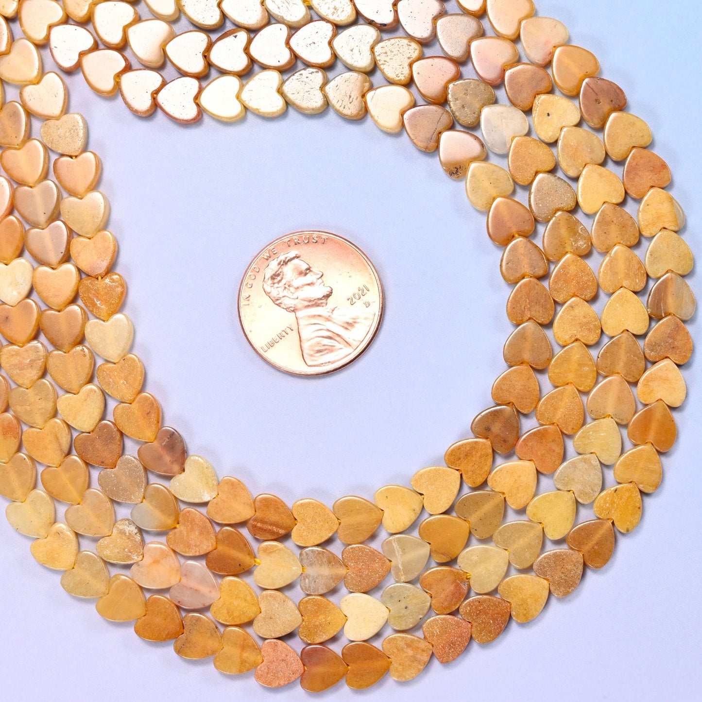 Gold Silk Jade Flat Heart Beads, warm honey and amber stone streaked with cream and pale apricot