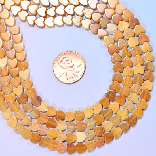 Gold Silk Jade Flat Heart Beads, warm honey and amber stone streaked with cream and pale apricot
