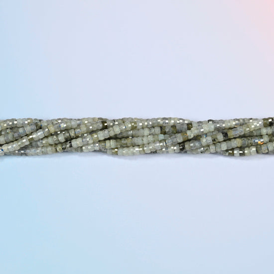 Strands of white labradorite faceted heishi disc beads twisted together in a horizontal row