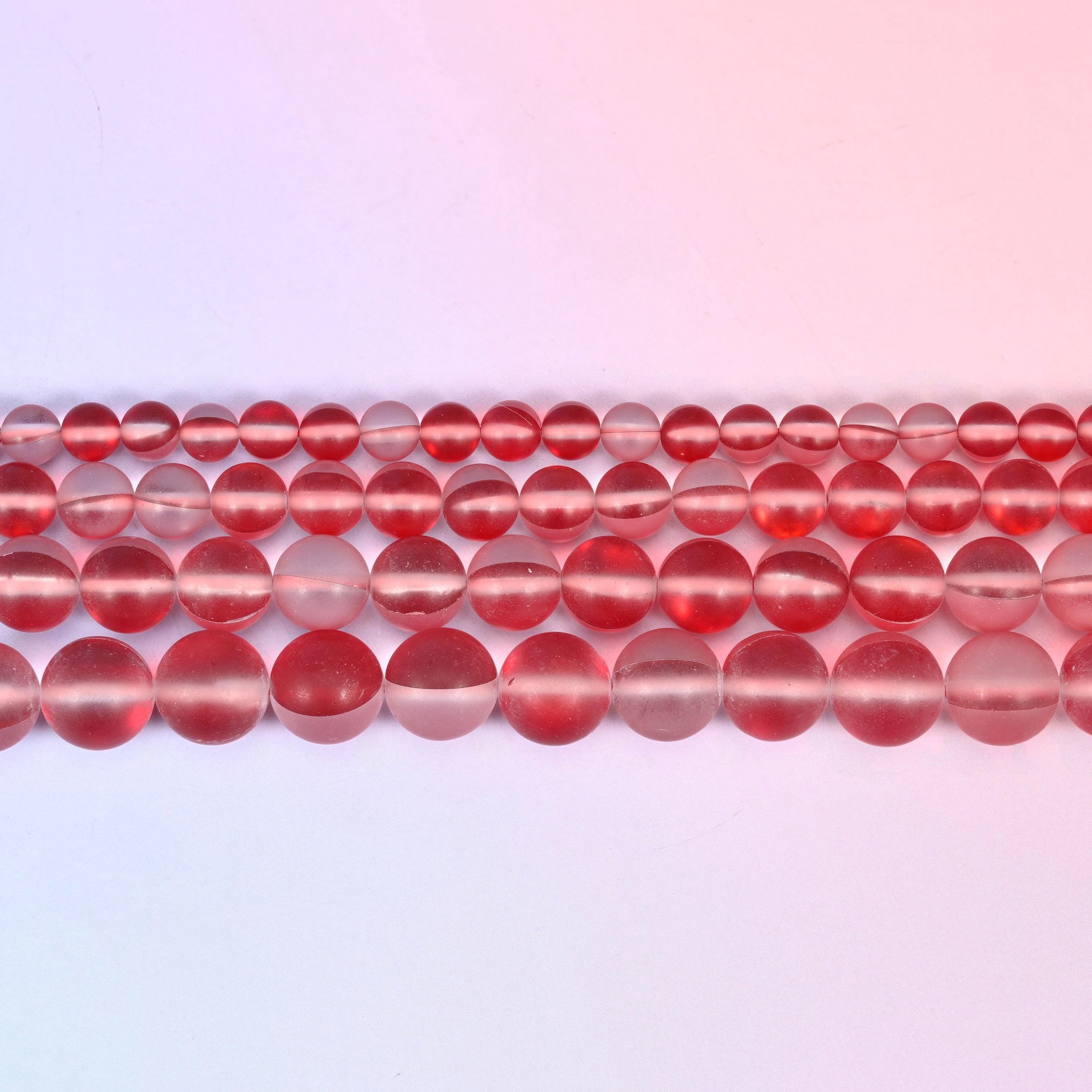 Matte glass beads in frosted cherry-red with a bright iridescent core