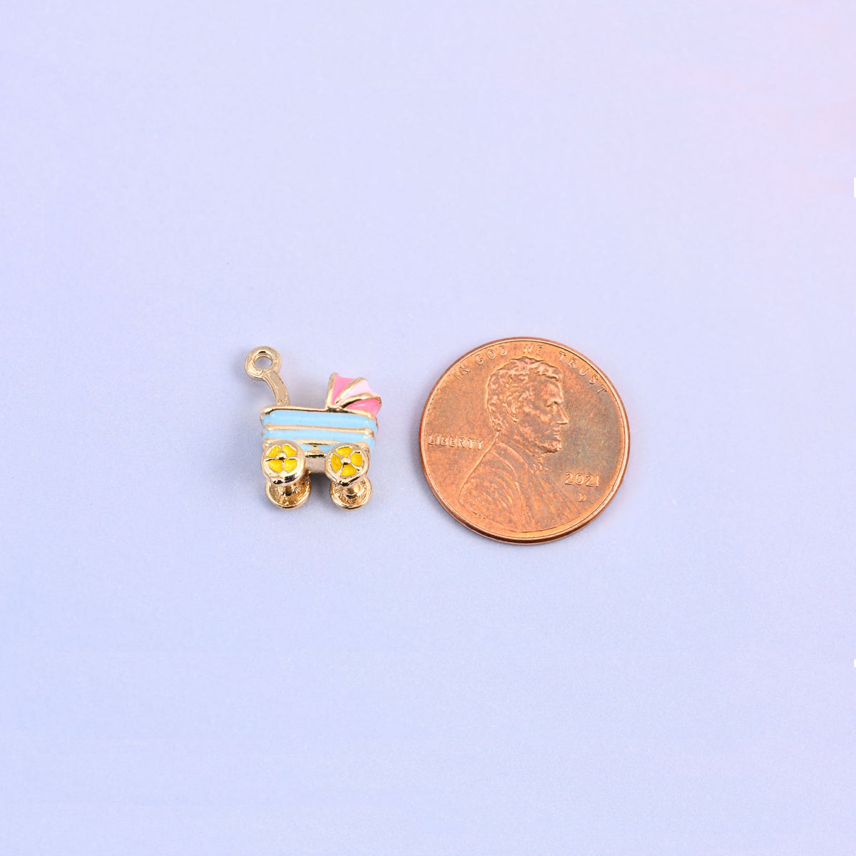 Single light blue stroller charm shown for scale at 14.57 x 12.7mm, enamel over 18K gold plated brass.