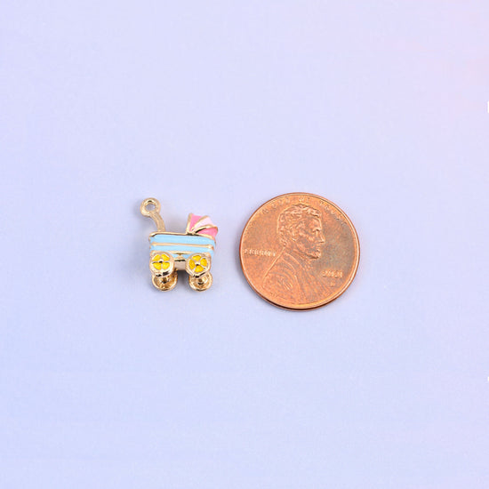 Single light blue stroller charm shown for scale at 14.57 x 12.7mm, enamel over 18K gold plated brass.
